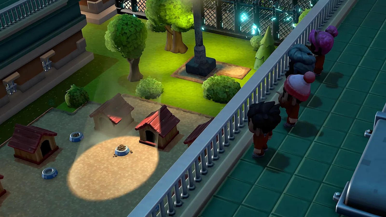 Inmates walk single file along a walled walkway beside the fenced dog kennels under floodlights in a scene from The Escapists 3